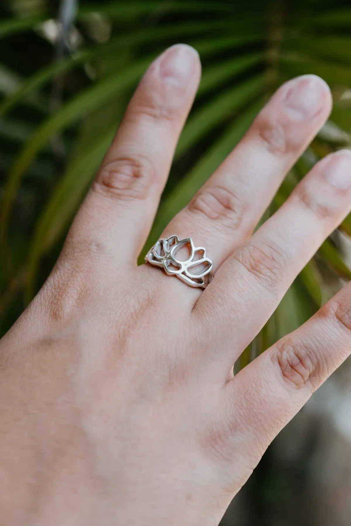 A lotus silver ring on a guest's hand